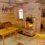 Brick wood-burning stove-fireplace in a wooden house
