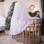 Тюлевый балдахин на деревянной кроватке для младенца
